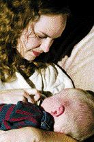 adoptive mother breastfeeding her baby